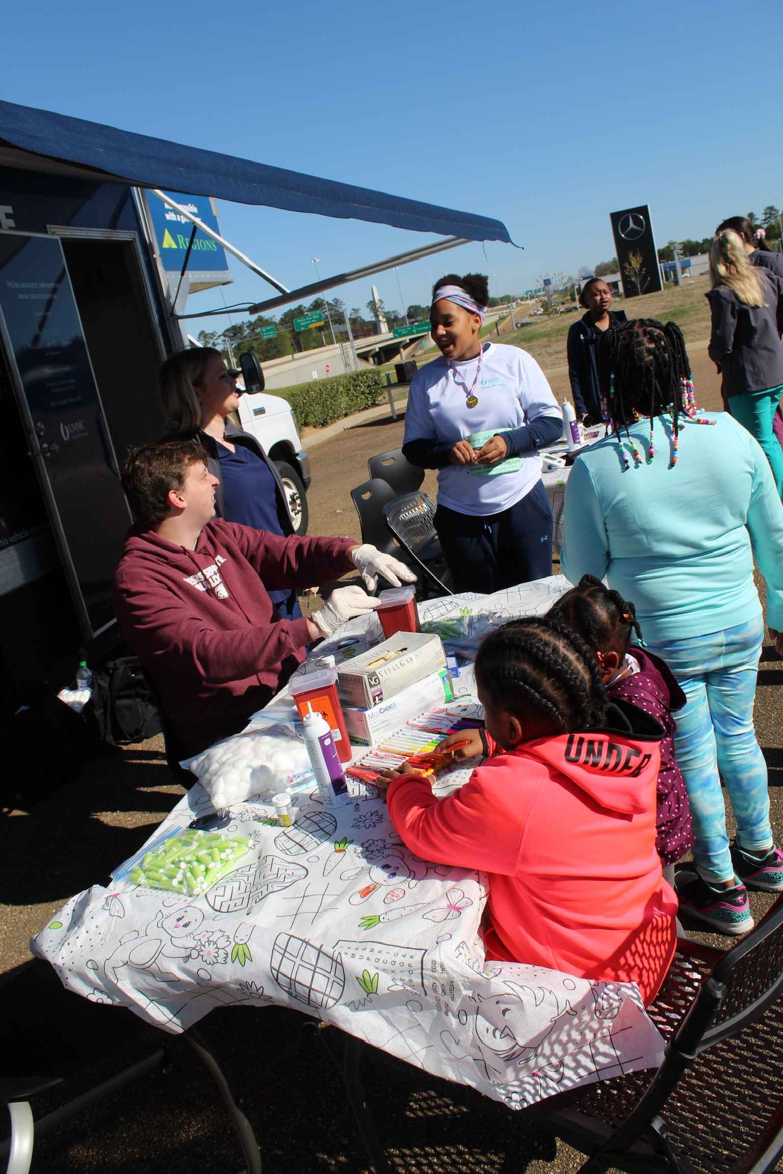 Attendees waiting to be evaluated at the Health Screening tent.